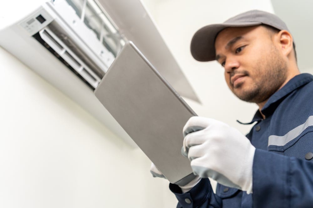 HVAC serviceman working through his maintenance checklist